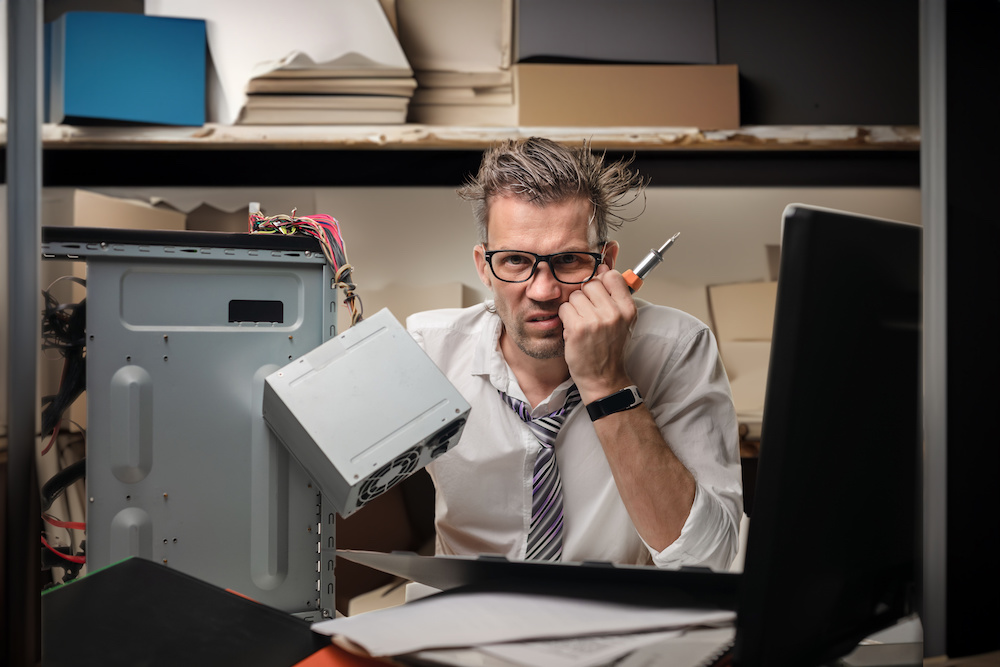 Office employee having a problem with pc. Hands-on office tech support.